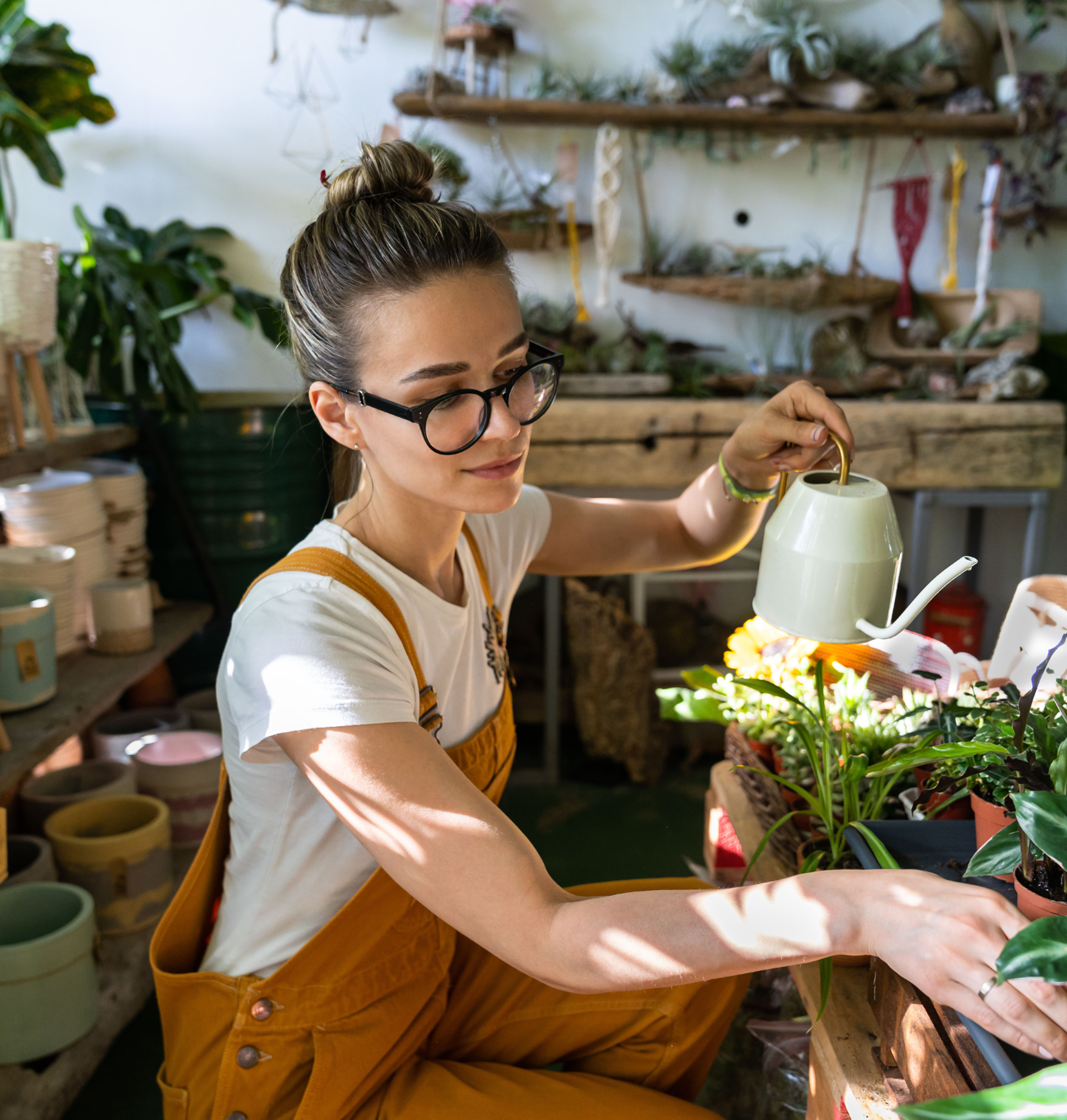 Business owner watering plants